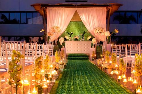 a wedding aisle with candles and flowers and lights at The Westin South Coast Plaza, Costa Mesa in Costa Mesa