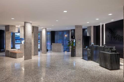a lobby of a building with pillars and windows at AC Hotel Miami Wynwood in Miami