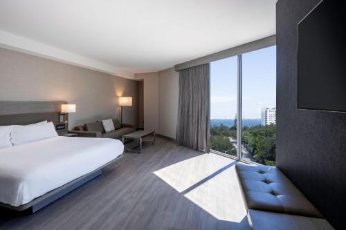 a hotel room with a bed and a large window at AC Hotel Miami Wynwood in Miami