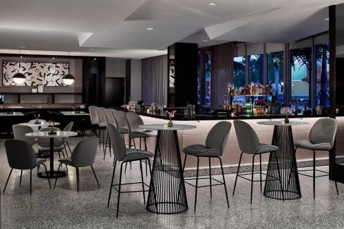 a restaurant with tables and chairs and a bar at AC Hotel Miami Wynwood in Miami