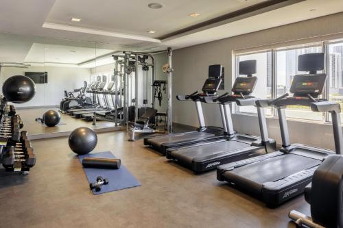 a gym with treadmills and ellipticals in a room at AC Hotel Miami Wynwood in Miami
