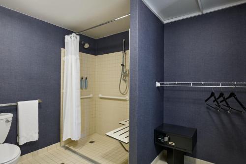 a bathroom with a shower and a toilet at Residence Inn Arlington Capital View in Arlington