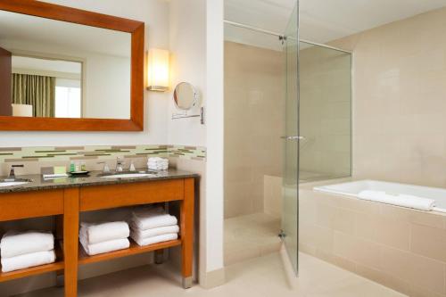 a bathroom with a shower and a sink and a tub at The Westin Edina Galleria in Edina