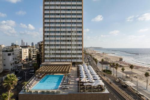 a hotel with a swimming pool and the beach at Sheraton Grand Tel Aviv in Tel Aviv