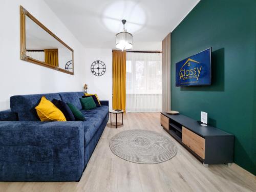 a living room with a blue couch and a table at CLASSY APARTMENTS - Gdynia - Na Wzgórzu Deluxe in Gdynia