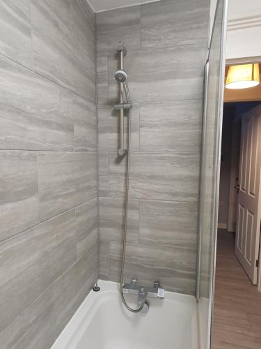 a shower in a bathroom with a bath tub at Serviced Accommodation near London and Stansted - 2 bedrooms  in Harlow