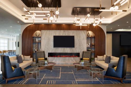 a lobby with a couch and a fire place at Courtyard by Marriott Kitchener in Kitchener