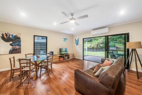 a living room with a couch and a table at Cockatoo Hideaway- Cabin in Montville