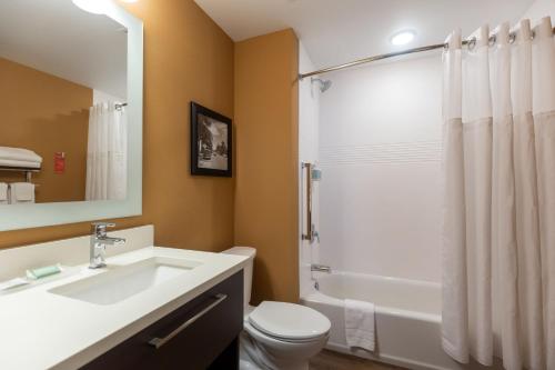 a bathroom with a sink and a toilet and a shower at TownePlace Suites Naples in Naples