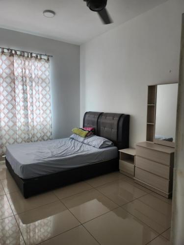 a bedroom with a bed and a television in it at Meridin Bayvue in Masai