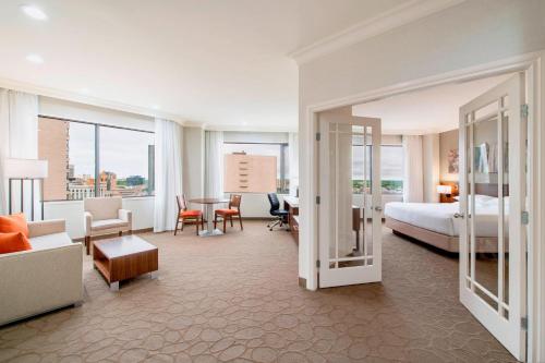 Delta Hotels by Marriott Regina في ريجينا: فندق غرفه بسرير وصاله