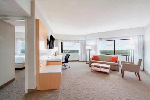 a hotel room with a bedroom and a living room at Delta Hotels by Marriott Regina in Regina