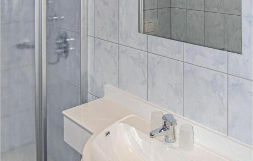 a white bathroom with a sink and a shower at Nice Apartment In Hainzenberg With House A Mountain View in Zell am Ziller