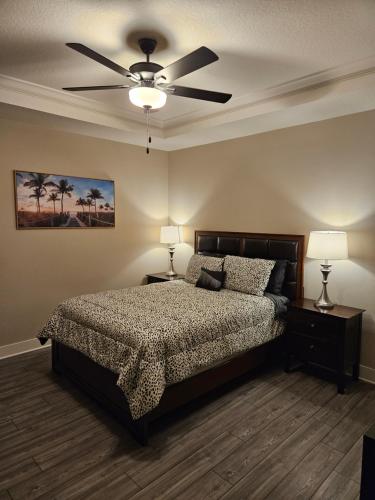 a bedroom with a bed and a ceiling fan at Endearing Private Bedroom in Shared House in Reunion Resort in Kissimmee