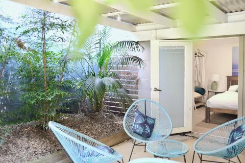 a room with blue chairs and a bedroom at Dalziel Lodge in Sydney