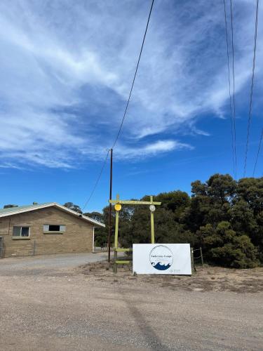 a sign sitting on the side of a road at Tuckerway - Beach Stay Property for Large Groups! in Port Vincent
