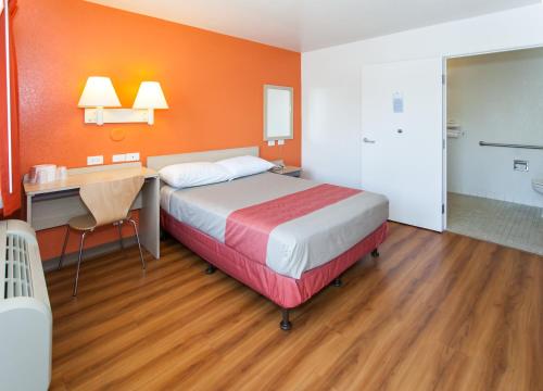 a hotel room with a bed and a desk and a desk at Motel 6-Rosemead, CA - Los Angeles in Rosemead