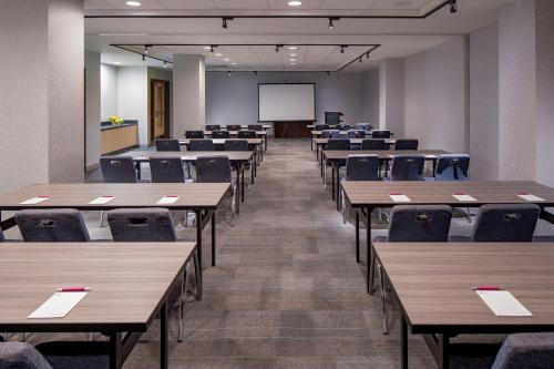 an empty classroom with tables and chairs and a whiteboard at Aloft New Orleans Downtown in New Orleans