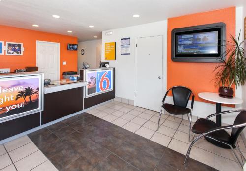 a waiting room with a counter and a tv on the wall at Motel 6-Rosemead, CA - Los Angeles in Rosemead