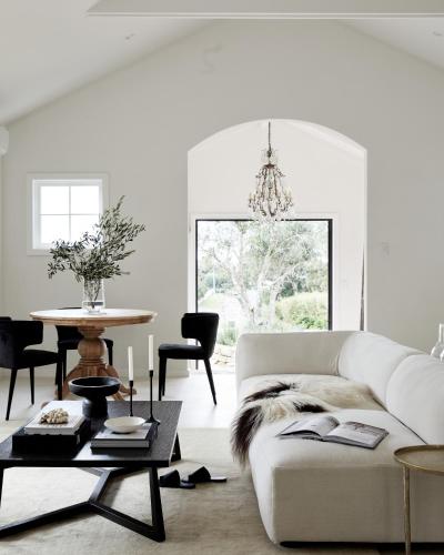 a living room with a white couch and a table at Le Viti Barn in Newrybar