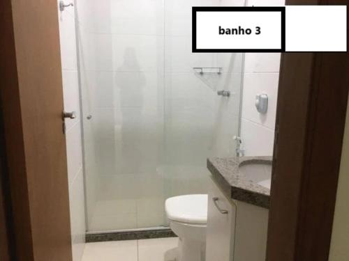 a bathroom with a shower with a toilet and a sink at Ap Enseada Azul ES Pé na Areia in Guarapari