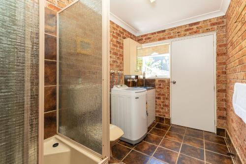 a bathroom with a shower and a toilet at Coastal Cove in Smiths Lake