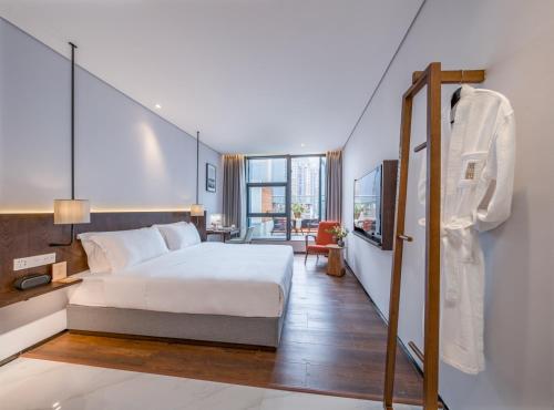 a hotel room with a bed and a balcony at Wuyu Hotel - Chongqing Jiangbei Airport & Light Rail in Chongqing