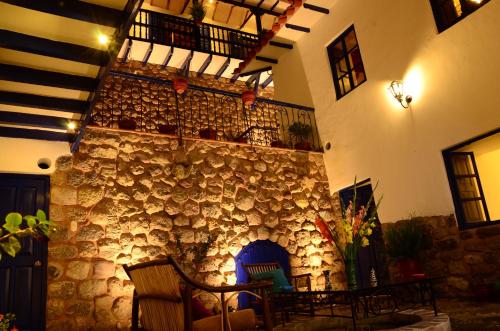 a stone building with a fireplace in a room at Rumi Wasi in Cusco