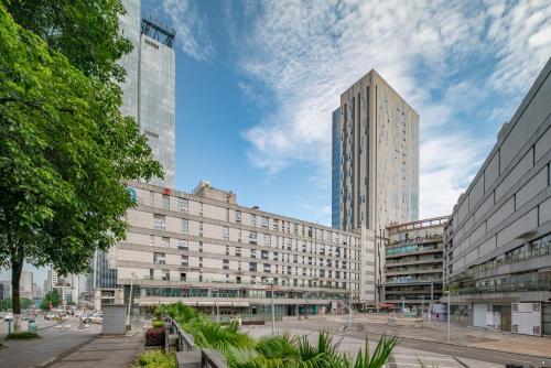 a large building in a city with tall buildings at Wuyu Hotel - Chongqing Liangjiang Happiness Plaza in Chongqing