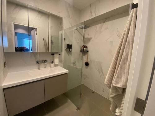 a bathroom with a sink and a glass shower at Apartamento vista al mar, Barranco, The Modern in Lima