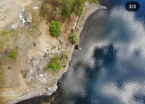 an aerial view of an island in the water at Cabañas Icalmahuida in Icalma