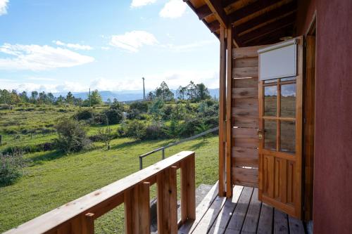 a porch of a cabin with a door and a view at El Camino Suites in Villa Berna