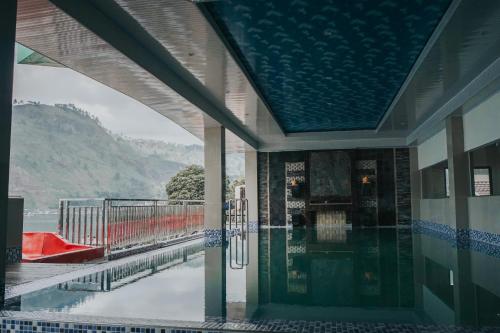 a building with a view of the water from a balcony at Agape Hotel Haranggaol in Haranggaul