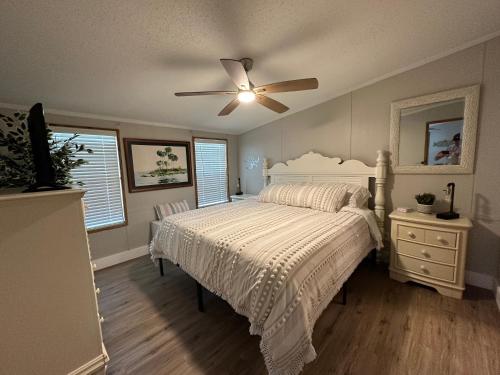 a bedroom with a bed and a ceiling fan at Waterfront Canal in Satsuma Florida in Satsuma