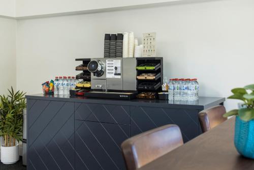 a black counter with a coffee maker on top of it at The Abbott Boutique Hotel in Cairns