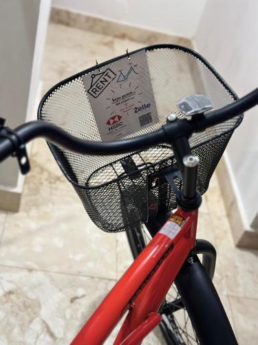 a basket on a bike with a sign in it at Lovely 1 Bedroom Condo with plunge pool In Bahia Principe Golf Resort in Akumal