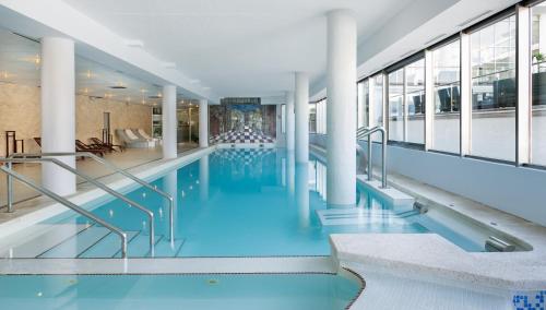 a swimming pool with blue water in a building at Hotel Sun Palace Albir & Spa in Albir