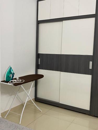 a room with white lockers and a table at SAIGONESE Studio in Ho Chi Minh City