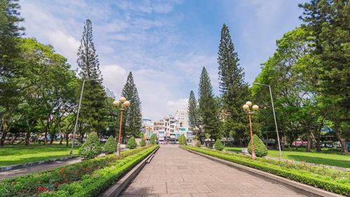a walk way in a park with trees and flowers at SAIGONESE Studio in Ho Chi Minh City