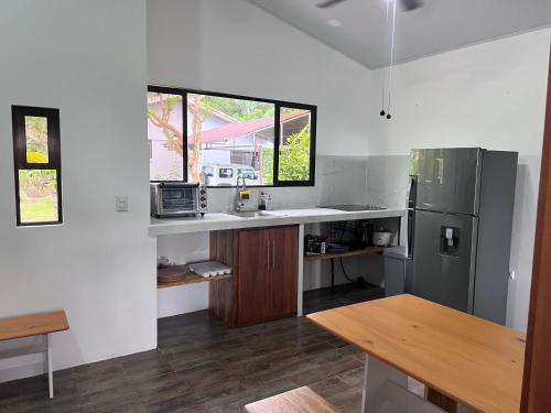 a kitchen with a sink and a refrigerator at Three Soul 3 in Jabillos