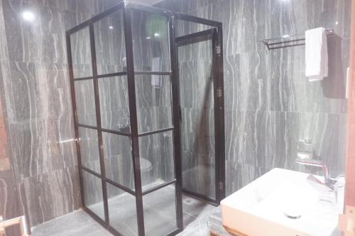a bathroom with a shower and a toilet and a sink at Agape Hotel Haranggaol in Haranggaul