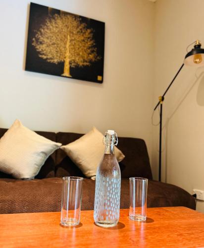 a table with a bottle and two glasses on it at Nanai Resort Salakphet in Ko Chang