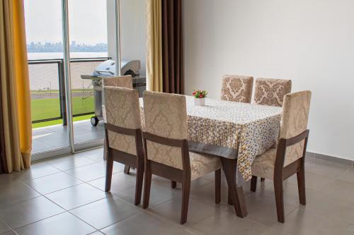 a dining room table and chairs with a table and a window at Parana Playa 1103 in Encarnación