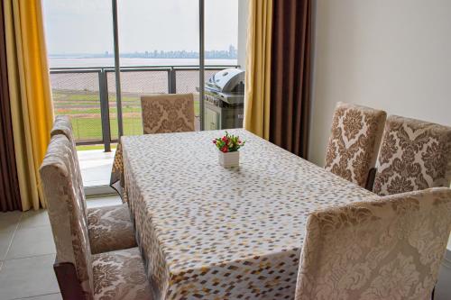 a table and chairs with a table and flowers on it at Parana Playa 1103 in Encarnación