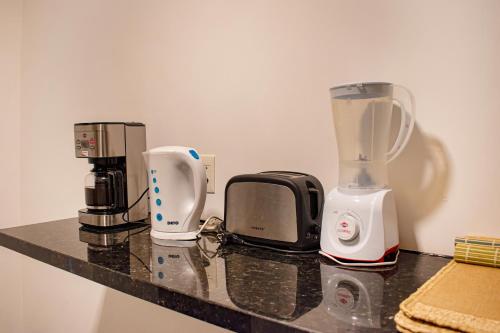 a counter with three appliances sitting on top of it at Parana Playa 1103 in Encarnación