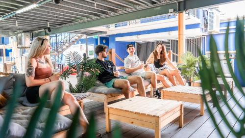 a group of people sitting on the deck of a boat at Mad Monkey Jungle in Cairns