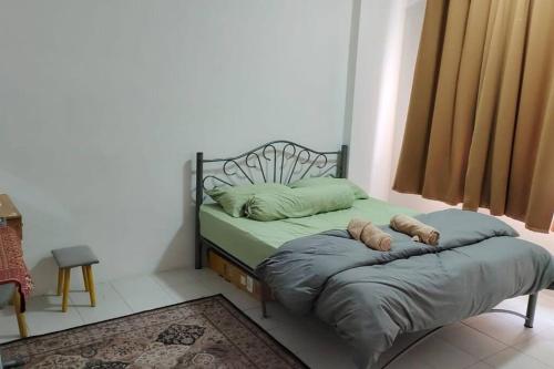 a bed with two pillows on it in a room at CANA Homestay Petaling Jaya in Petaling Jaya