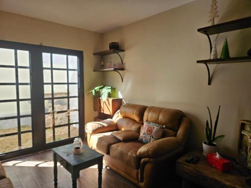 a living room with a couch and a table at Loft Candelaria Pacaya in Antigua Guatemala