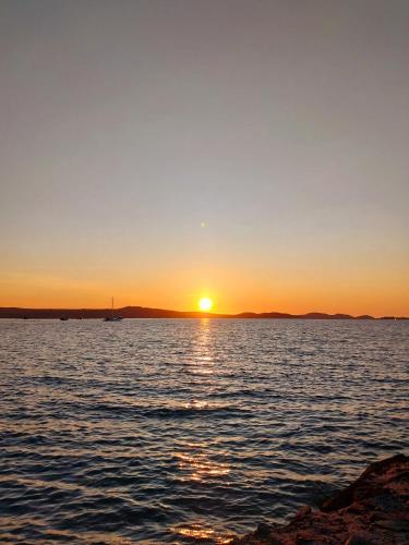 a sunset over a large body of water at The Dugongs' Rest in Horn