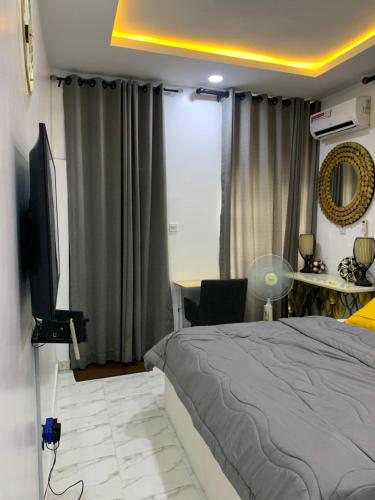 a bedroom with a bed and a flat screen tv at Beautiful single room studio apartment in Ilasan lekki magnanimous in Lekki